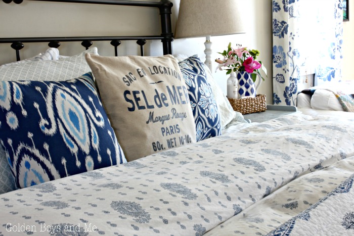 Sel de mer throw pillow in master bedroom with blue and white decor - www.goldenboysandme.com