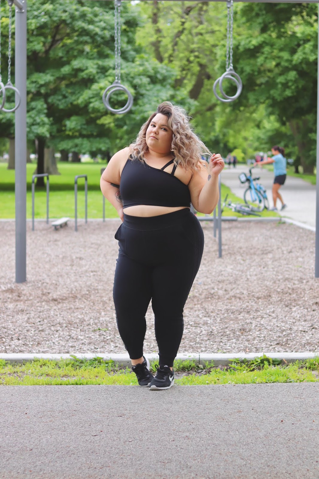 Chicago Plus Size Petite Fashion Blogger, YouTuber, influencer and model Natalie Craig, of Natalie in the City, reviews Fabletics' Ease Two Piece Outfit Jogger and one shoulder sports bra set.
