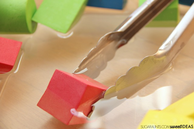 Use kitchen tongs to work on the lumbrical intrinsic muscles of the hands to build strength in handwriting, using tongs for this color search and hand eye coordination activity for kids.