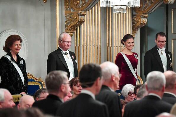 Queen Silvia and Prince Daniel. Crown Princess Victoria wore Filippa K faux fur jacket. burgundy. red velvet dress. Princess Madeleine