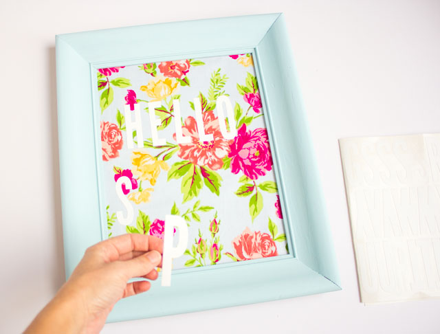 Such a fun thrift store makeover! Transform an old picture frame into this colorful Hello Spring fabric art! Such a fun thrift store makeover! Transform an old picture frame into this colorful Hello Spring fabric art!