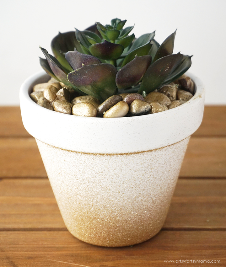 With a little bit of paint, you can turn inexpensive terra cotta pots into trendy DIY Gold Ombre Planters!