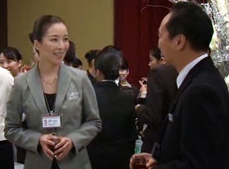 Mikami and Captain Sakurada smile at each other at the reception.