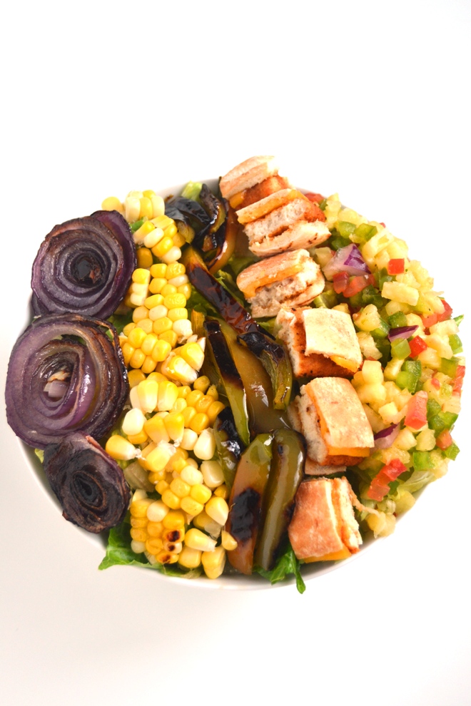 Pineapple Salsa Chicken Salad is loaded with homemade fresh pineapple salsa, grilled corn, peppers and onions, chicken and topped with a garlic lime vinaigrette! www.nutritionistreviews.com