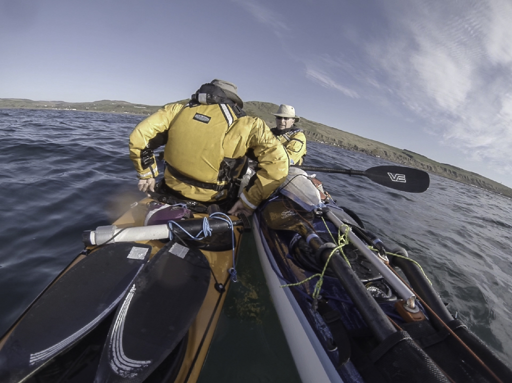 Sea kayaking with Assisted reentry after a capsize with a Flat Earth kayak sail.