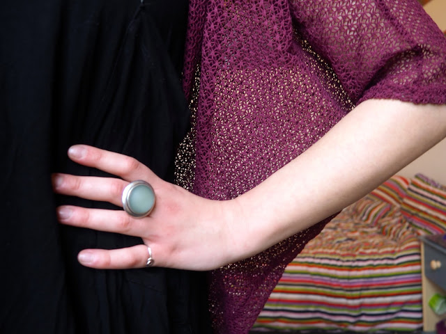 Pull the Lever | Disneybound Yzma outfit jewellery details of large round blue stone ring, with black slouch dress and pink knit cardigan