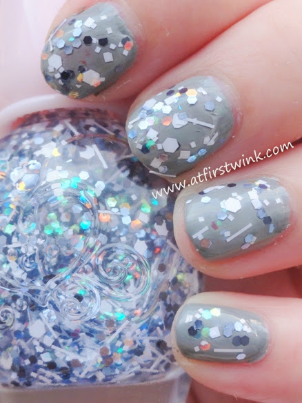 grey base color nail polish and glitters on top