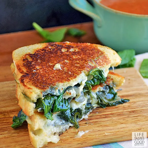 Spinach Artichoke Grilled Cheese | by Life Tastes Good is the classic dip in sandwich form and totally tasty! This Grilled Cheese sandwich is loaded with fresh spinach, artichokes, and lots of ooey gooey, melty cheese! It's a classic flavor combo, and I'm excited to share it with you in this tasty sandwich recipe! #SundaySupper