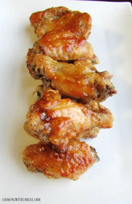 A little sweet and a little heat will have you licking your fingers and coming back for more! Peach habanero chicken wings are perfect game day food. peach habanero chicken hot wings lined up on white background