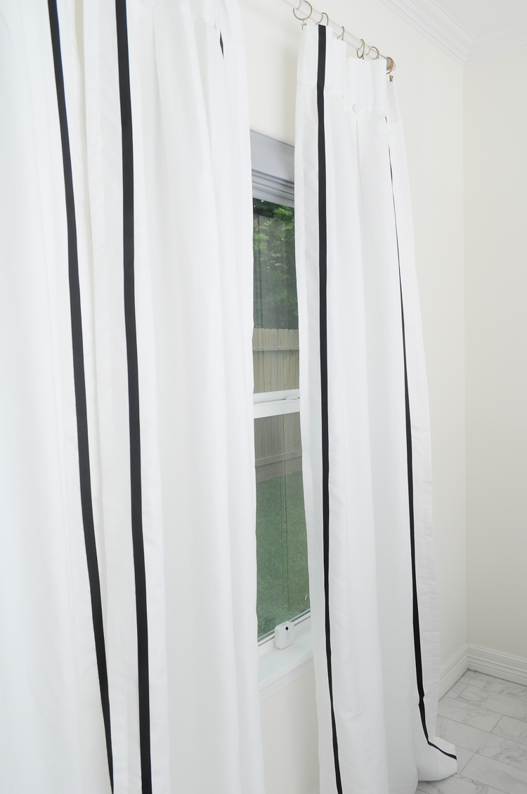 Plain store bought curtains get spruced up with some black grosgrain ribbon on a lucite rod. Plain store bought curtains get spruced up with some black grosgrain ribbon on a lucite rod.