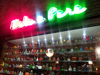 The neon sign and display of glass apples and pears at Mele e Pere, Soho