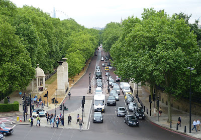 View down Constitution Hill from the top of the Wellington Arch  showing the Green Park on the left  and Buckingham Palace gardens on the right
