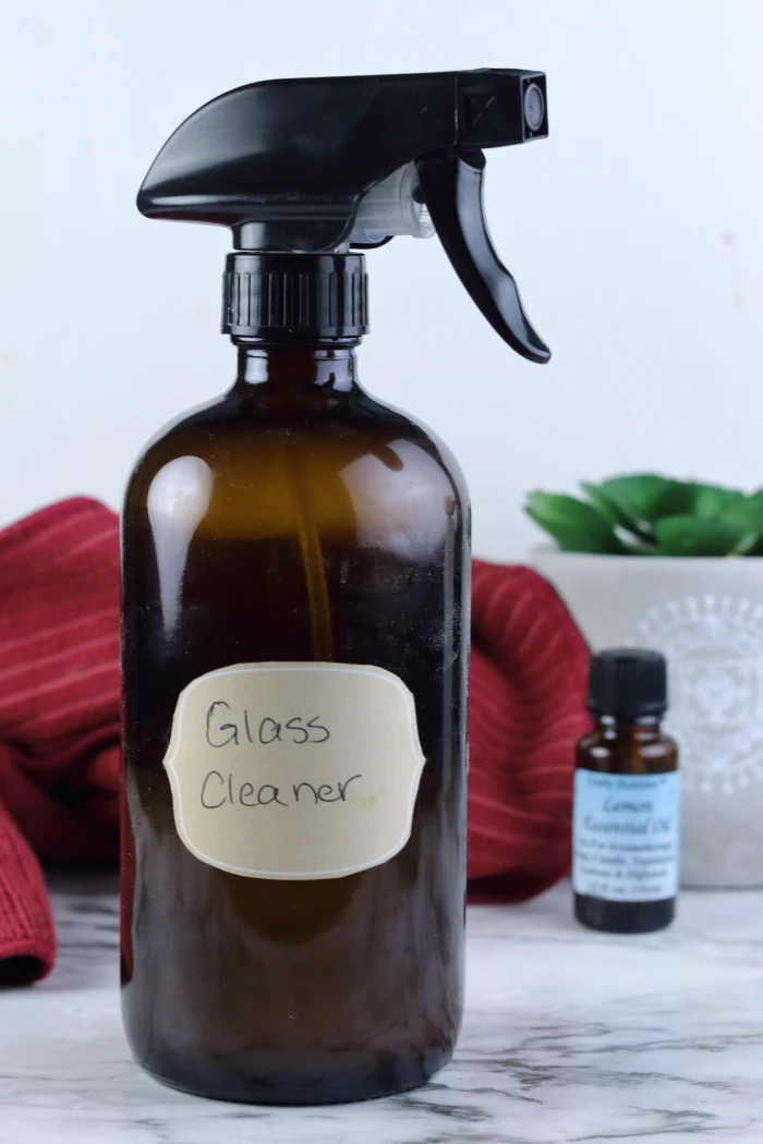 This diy window and mirror cleaner is an easy diy cleaning products recipe to make.  Cleaning with essential oils helps you get your home clean naturally.  This diy window cleaner natural has lemon essential oil to cut create.  DIY window cleaner essential oils for a natural clean.  Window cleaner homemade streak free thanks to a secret ingredient.  Window cleaner homemade with vinegar and rubbing alcohol.  #window #glass #mirror #essentialoils #diy #recipe #cleaning #naturalcleaning #ecofriendly #natural