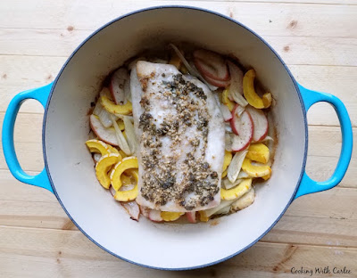 turquoise dutch oven with cooked apples, squash, pork loin and more fresh from oven.