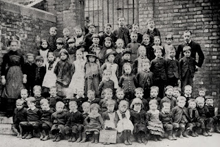 A black and white photo of around 60 kids and 2 teachers at Bath Lane School