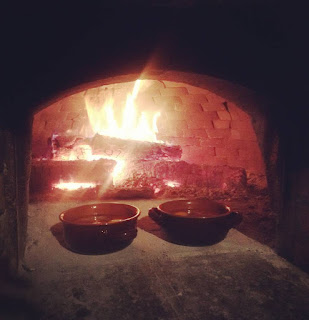 Fire cooked vegetarian option Two bowls in front of the fire in a traditional Tuscan oven