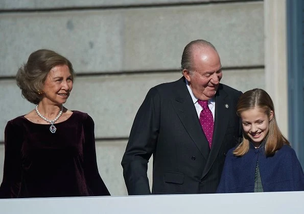 Queen Letizia wore Carolina Herrera red dress and clutch, Magrit pumps. Princess Leonor, Infanta Sofía and Queen Sofia