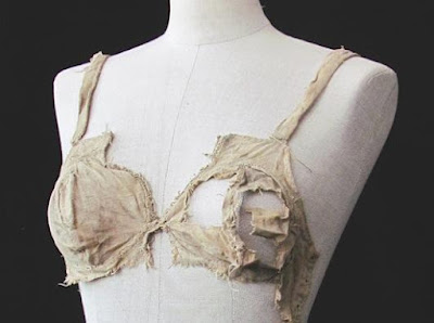 Photograph of a dummy form with a torn bra on it.