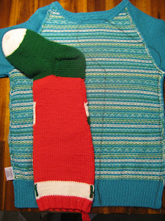 cutting the stocking pattern out of the sweater