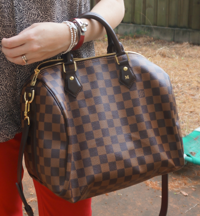 Louis Vuitton Damier Ebene 30 speedy bandouliere worn with red skinny jeans