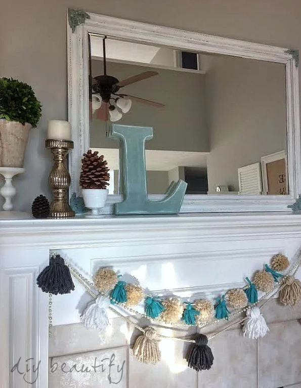 neutral mantel with pops of color in the monogram and tassel garland