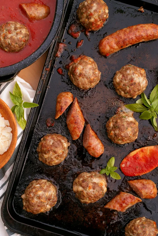 Sheet Pan Meatballs and Sausage that are perfectly cooked in the oven can be simmered in pasta sauce, served on crusty rolls as subs, or frozen for quick and easy meals later.  You will love this recipe!