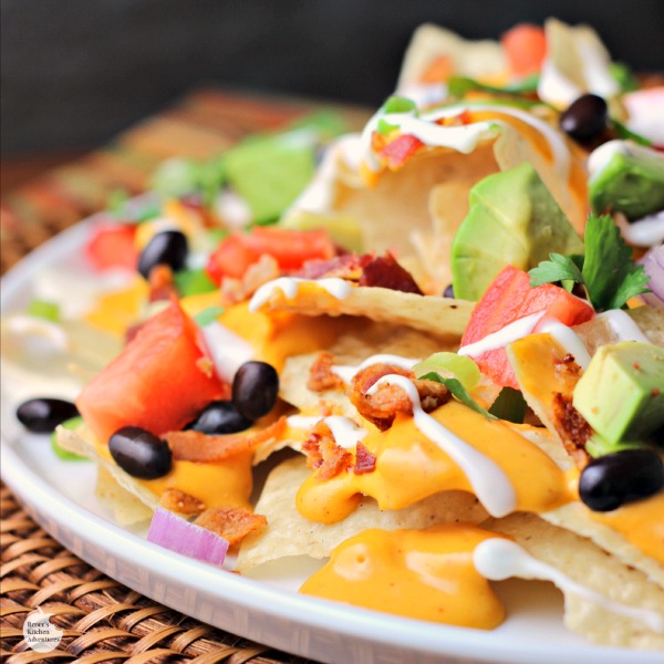Chipotle Ranch Bacon Cheddar Nachos | by Renee's Kitchen Adventures - Easy recipe for a delicious appetizer or fun main dish the whole family will love! Cheesy goodness with every bite! #SimmeredinTradition Chipotle Ranch Bacon Cheddar Nachos | by Renee's Kitchen Adventures - Easy recipe for a delicious appetizer or fun main dish the whole family will love! Cheesy goodness with every bite! #SimmeredinTradition