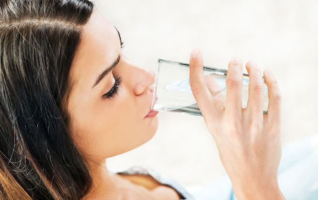 a beautiful lady is drinking water