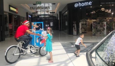 Fourways Mall Christmas Elf on bicycle at Fourways Mall handing out crackers and popcorn