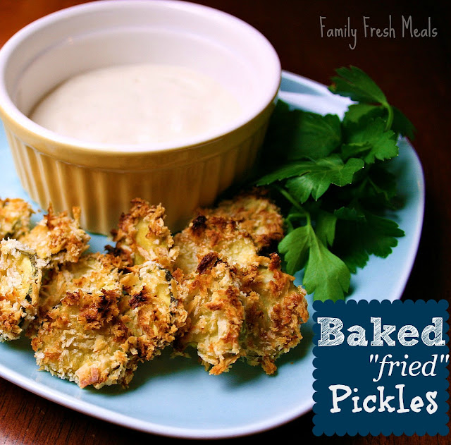 Baked Fried Pickles on a blue plate with a cup of dipping sauce