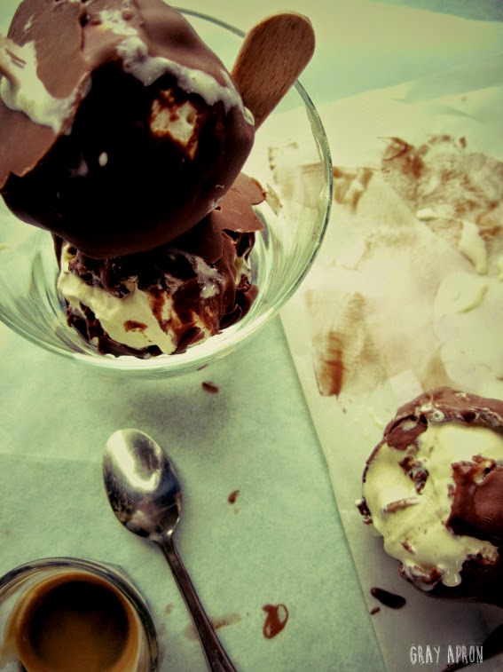 gray apron Chocolate covered ice cream on a stick