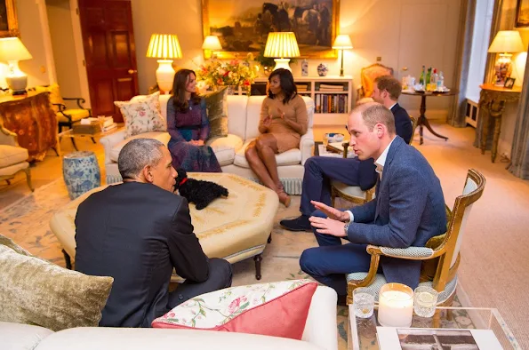 Prince William, Duke of Cambridge speaks with US President Barack Obama as Catherine, Duchess of Cambridge speaks with First Lady of the United States Michelle Obama and Prince Harry in the Drawing Room of Apartment 1A Kensington Palace