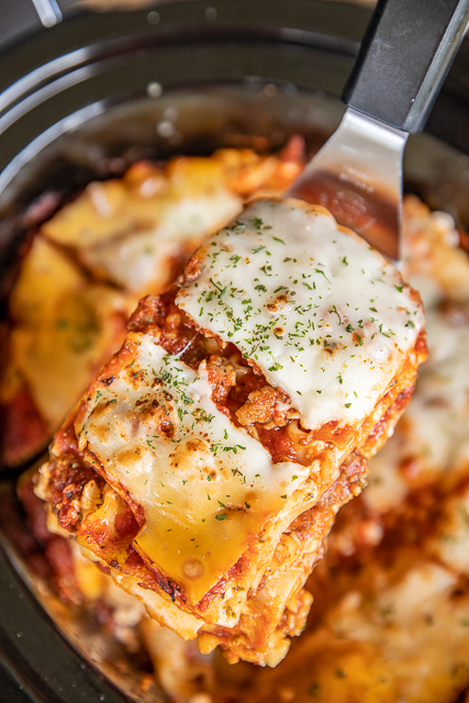 Slow Cooker Lasagna - our favorite lasagna recipe made in the slow cooker! SO easy! No need to boil the noodles - just toss them in the slow cooker unbaked.They will cook along with the lasagna in the slow cooker. Italian sausage, cottage cheese, egg, parsley, spaghetti sauce, tomato sauce, lasagna noodles, mozzarella and parmesan. Serve with some garlic bread and a salad. Can freeze leftovers for later. We LOVE this lasagna casserole recipe!!! #crockpot #slowcooker #lasagna Slow Cooker Lasagna - our favorite lasagna recipe made in the slow cooker! SO easy! No need to boil the noodles - just toss them in the slow cooker unbaked.They will cook along with the lasagna in the slow cooker. Italian sausage, cottage cheese, egg, parsley, spaghetti sauce, tomato sauce, lasagna noodles, mozzarella and parmesan. Serve with some garlic bread and a salad. Can freeze leftovers for later. We LOVE this lasagna casserole recipe!!! #crockpot #slowcooker #lasagna