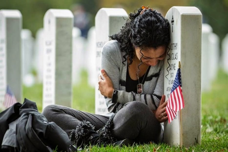 Thania Sayne leans on the headstone of her husband the day before their wedding anniversary on 16 October 2013. - The 63 Most Powerful Photos Ever Taken That Perfectly Capture The Human Experience