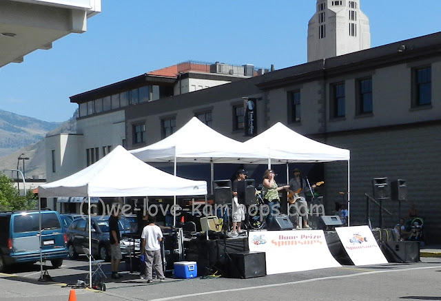 The band Blue Scarlett sing and the crowd enjoys their music during the car show