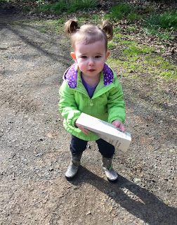 Montessori child holding a map for geography experience