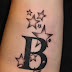 B letter and stars tattoo