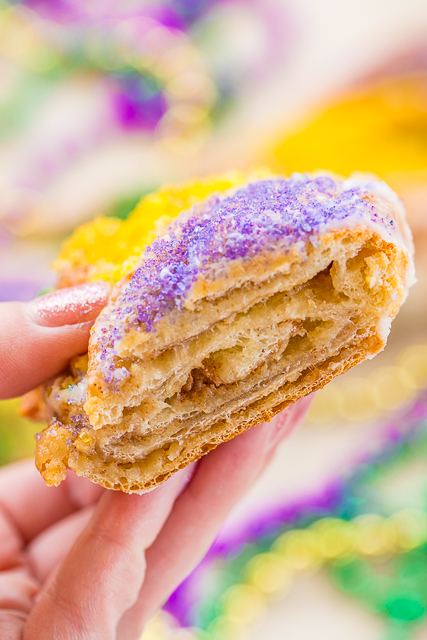 Easy King Cake Braid - perfect for Mardi Gras!!! Easy King Cake made with refrigerated french bread dough - stuffed with cream cheese, cinnamon and sugar. Topped with a quick powdered sugar and milk glaze and sprinkled with yellow, purple and green sugar. SO festive!!! Ready to eat in 30 minutes! Great for breakfast or dessert. I took this to a party and it was gone in a flash!!! YUM! #kingcake #mardigras Easy King Cake Braid - perfect for Mardi Gras!!! Easy King Cake made with refrigerated french bread dough - stuffed with cream cheese, cinnamon and sugar. Topped with a quick powdered sugar and milk glaze and sprinkled with yellow, purple and green sugar. SO festive!!! Ready to eat in 30 minutes! Great for breakfast or dessert. I took this to a party and it was gone in a flash!!! YUM! #kingcake #mardigras