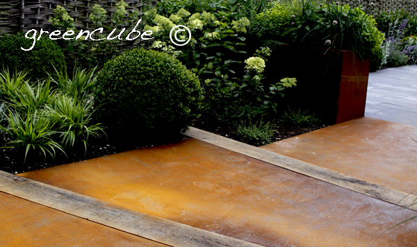 we have used strips of black limestone to create the terrace chosen for its uneven riven texture and soft colour to work with the cottage brick colour and