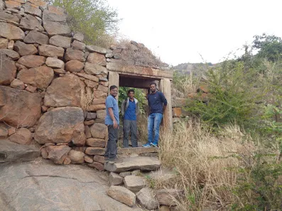 Ancient stone fort walls and gateway on the initial path of the Huthridurga Trek