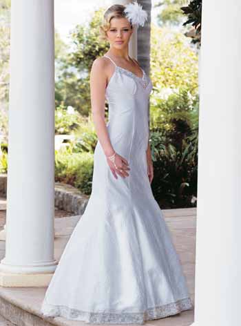 The vintage wedding dress designer dresses her with a beautiful selection of