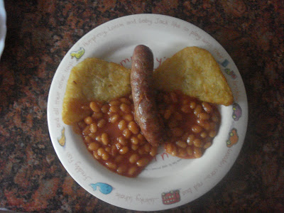 Butterfly made out of Hash browns, sausages and beans