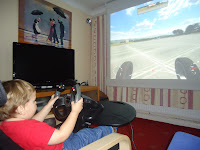 Baby Boy playing on F1 2010 on the projector