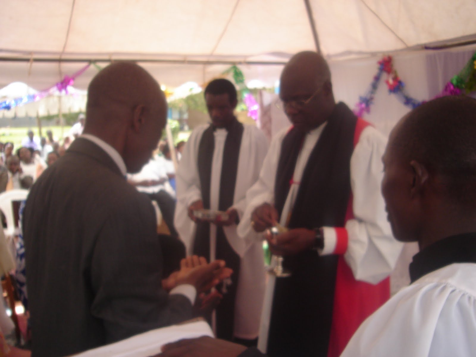 [Bishop+giving+holy+communion.JPG]