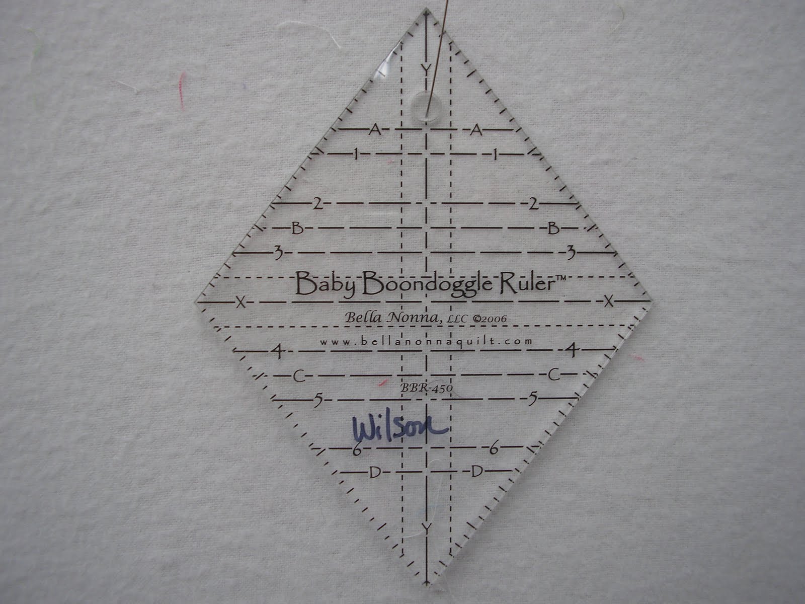 Thread and Bolts Quilting Baby Boondoggle ruler and a scrap box of fabrics