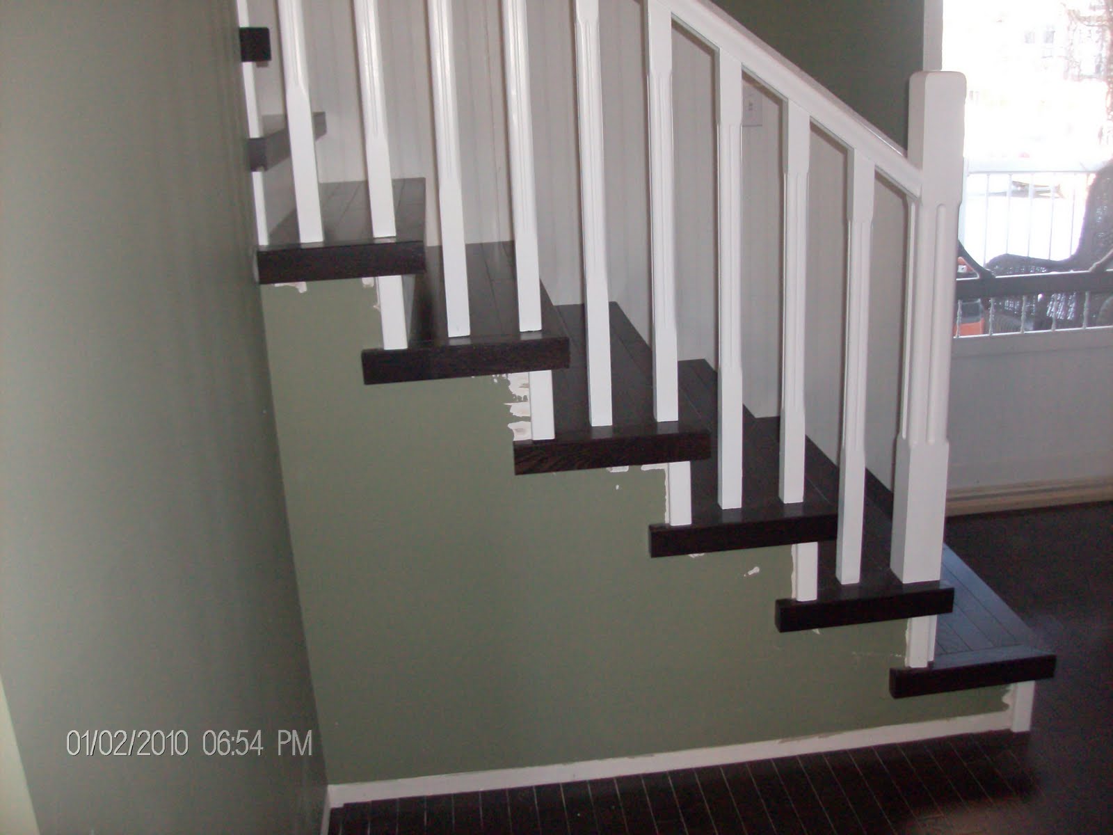 Hardwood Solutions Lethbridge Dark walnut stained oak stairs
