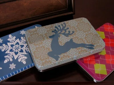 three patterned metal tins that are rectangular and shallow