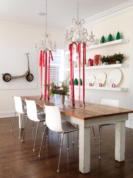 Farm table with chandeliers above strung with red ribbon for Christmas #holidaydecor