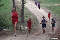 Runners in the GHSA Region 1-2A girls' 5K cross-country race negotiate a hill on the second kilometer of the course.