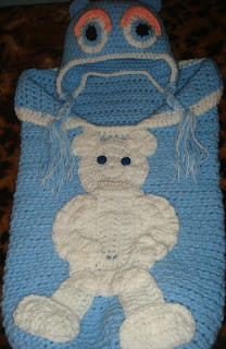crochet baby cocoon and crochet cap with earflaps for a newborn